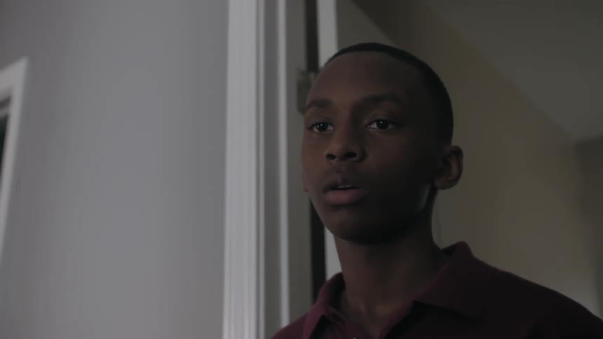 A teenager enters a doorway and freezes