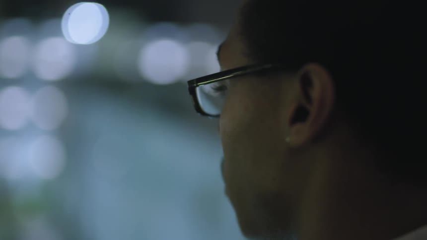 Man wearing glasses looks at bright lights