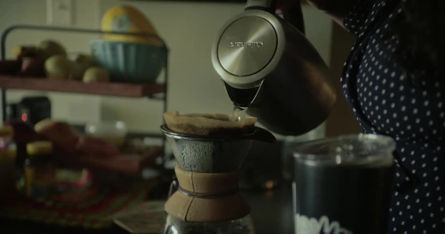Woman in the kitchen preparing coffee