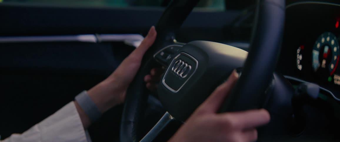 A person turns a steering wheel