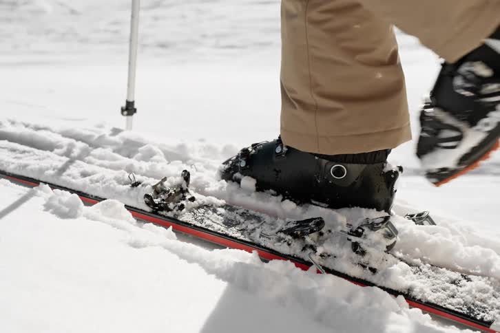 Stepping in to ski bindings then skiing off