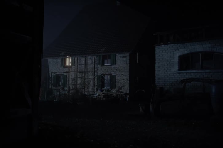 Light comes on inside the room of a house at night