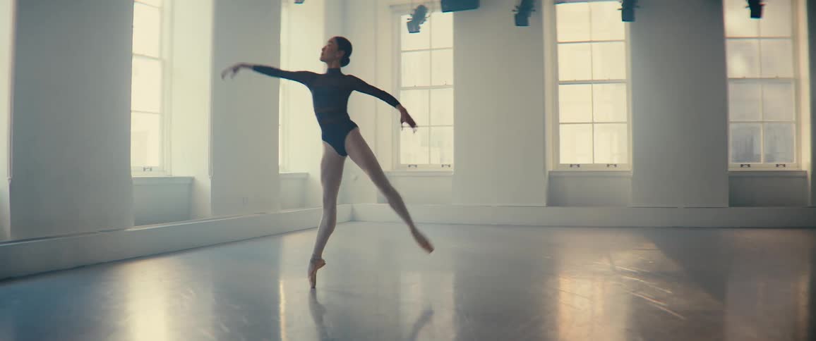 Woman dancing ballet in a room