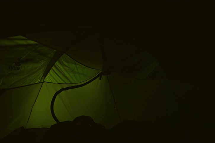 A clip of a person inside a camp tent