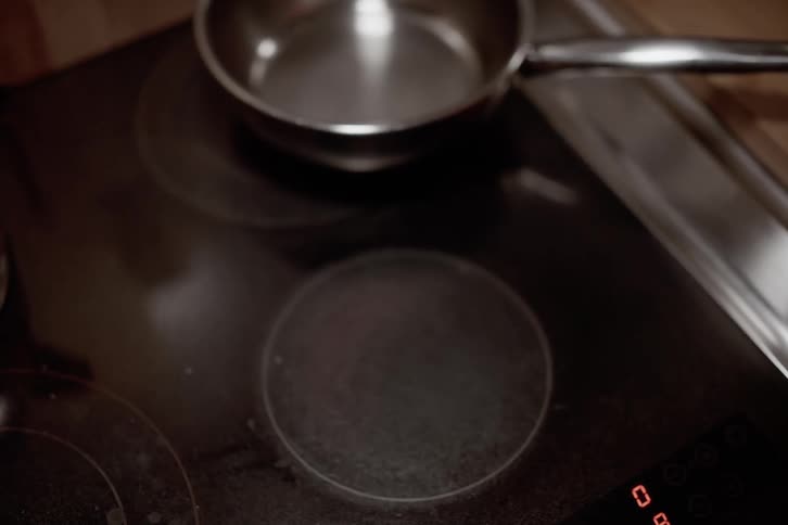 A footage of a person cooking in the kitchen