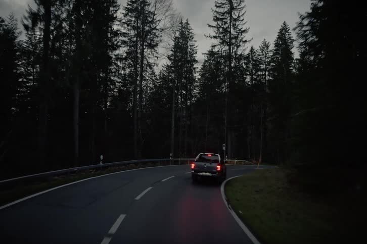A clip of a car moving on the free way in the woods
