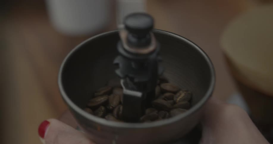 A barista grinds coffee beans