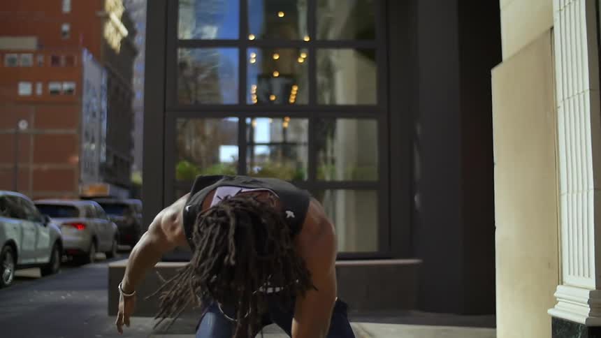 A man is dancing in the street outside