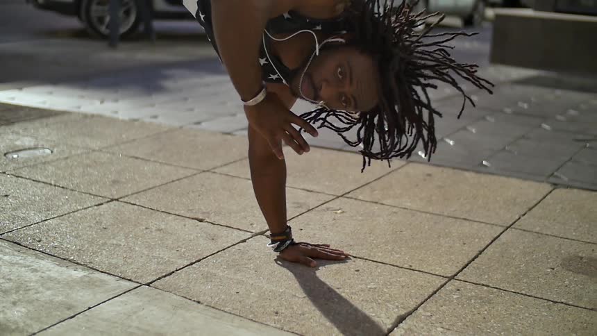 A man dances on the concrete