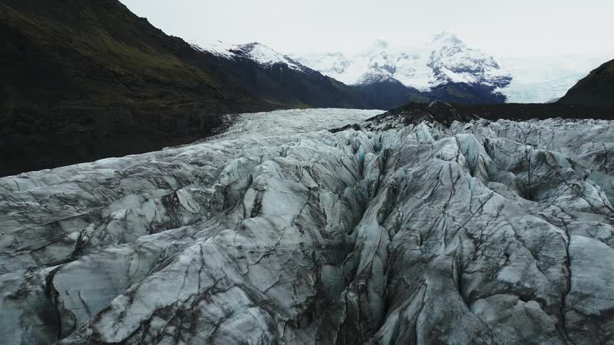 Aerial panorama of arctic rifts surrounded by mountains