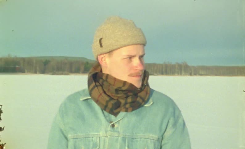 A young couple screams loudly while standing on a snowy field captured on vintage film