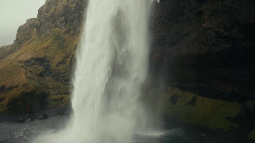 Mossy mountain with free falling waterfall