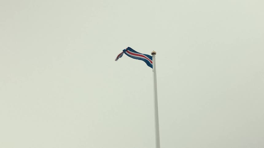 Upward view of a flag flying by air force against a cloudy sky