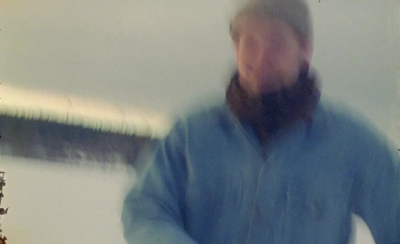 Man with a beanie on his head running in a snowy natural area