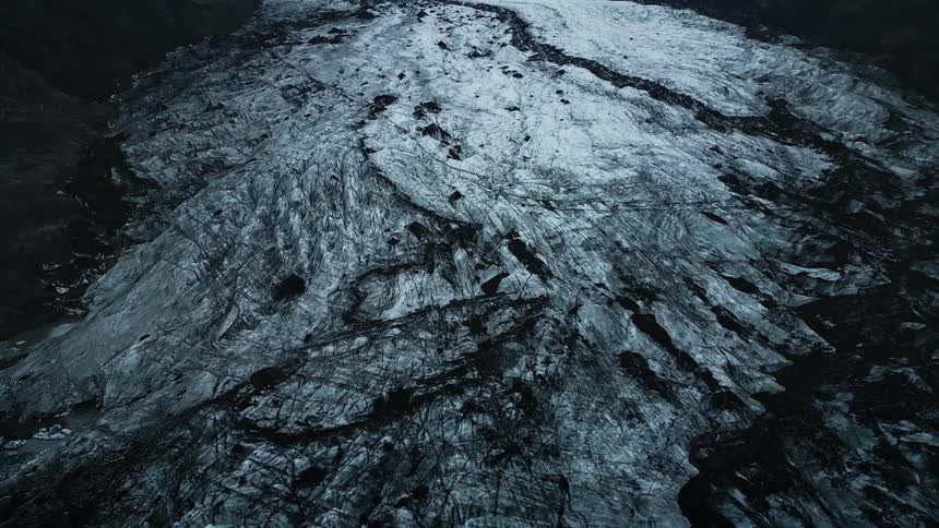 Aerial landscape of a snowy mountain scenery on a cloudy day