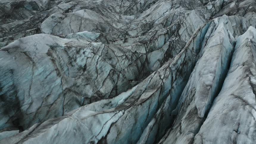 Aerial over crevice filled glacial rocks and ice