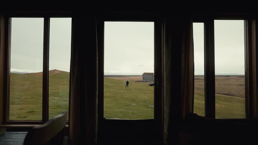View from a window of a person on a vast field