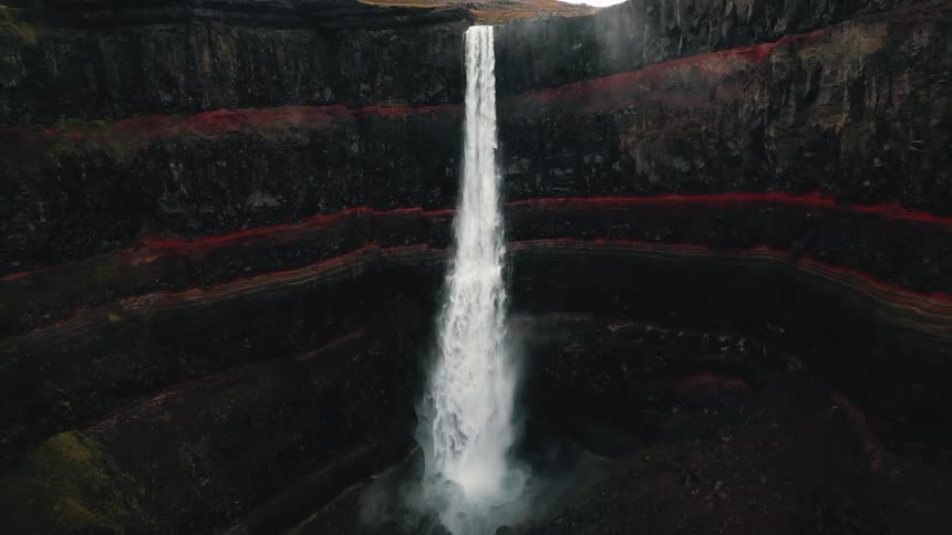 Aerial panorama of a mountain crater with waterfall