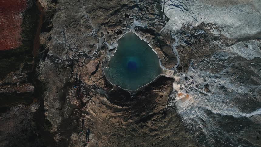 Aerial view of a natural lake on top of a rocky mountain