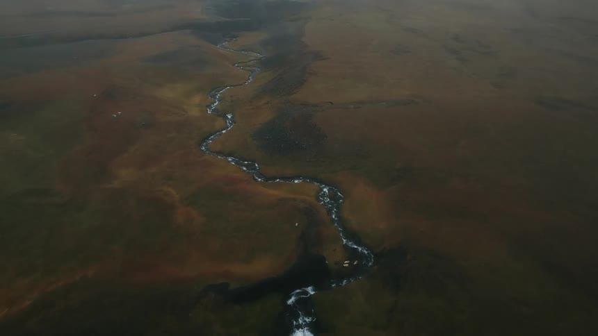 Aerial view of a winding river with ice
