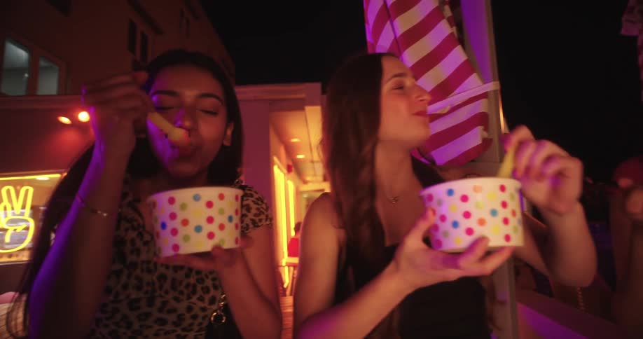Three young women eating ice cream