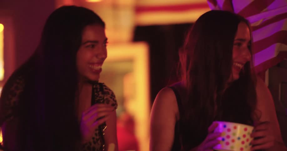 A group of teenage girls are having fun in town at night