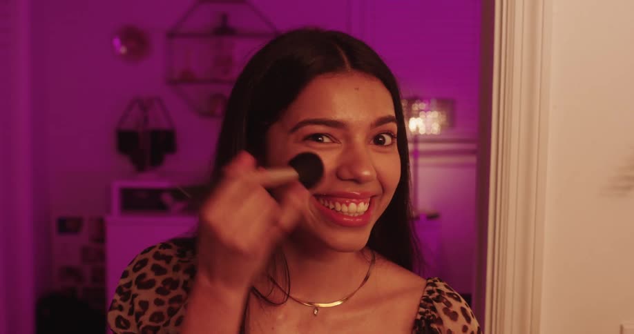 Portrait of a woman putting on makeup