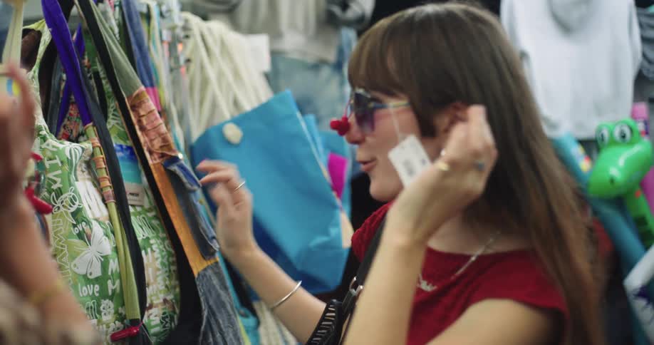 Woman trying on glasses in a store with happy facial expression
