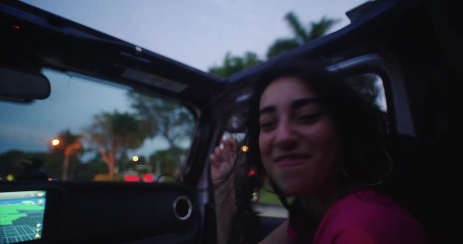 Woman enjoying happy music in a moving car