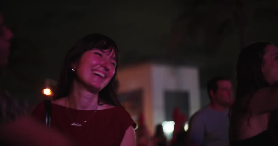Three friends having fun dancing at an outdoor night party
