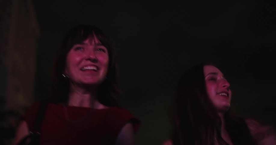 A group of teenage girls have fun dancing in the city at night