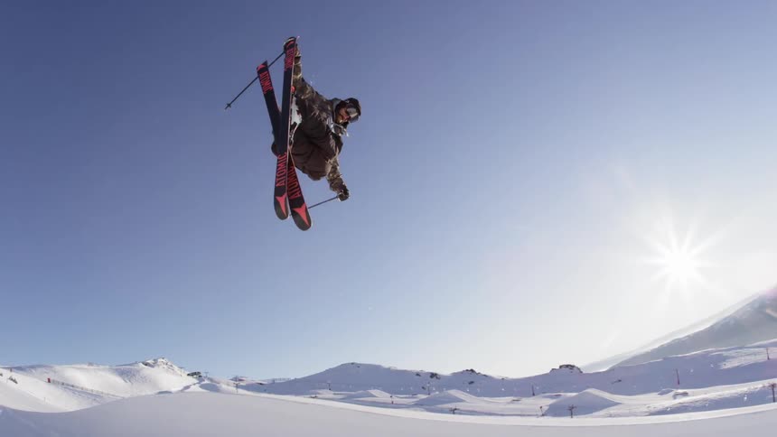 A person skis on a sunny winter day