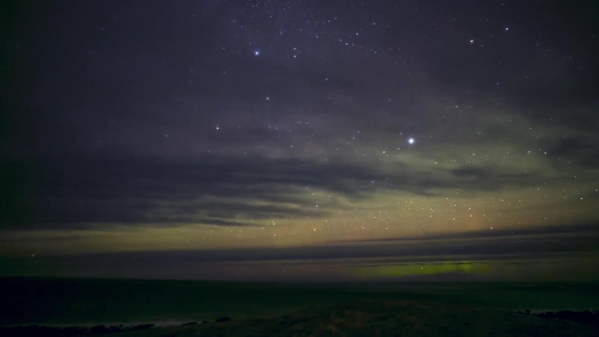 Seascape against a starry sky with Northern Lights
