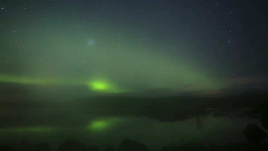 The aurora moves in the sky with the stars