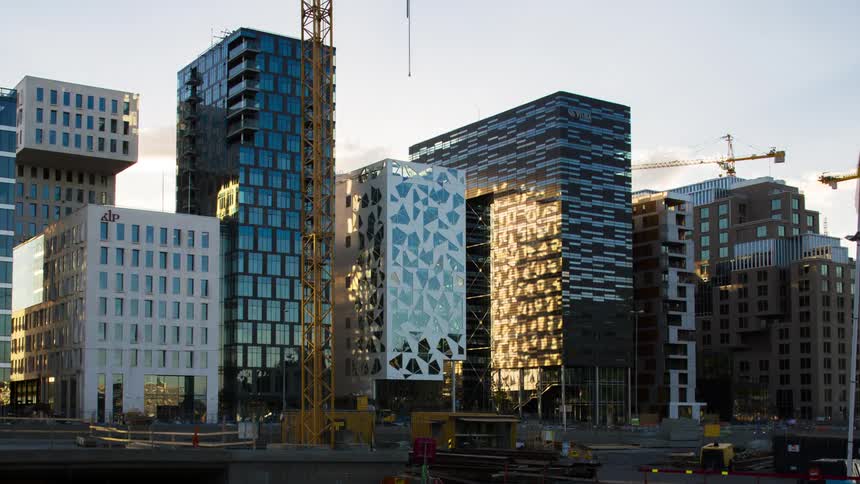 Traffic passes by the skyline that is under construction
