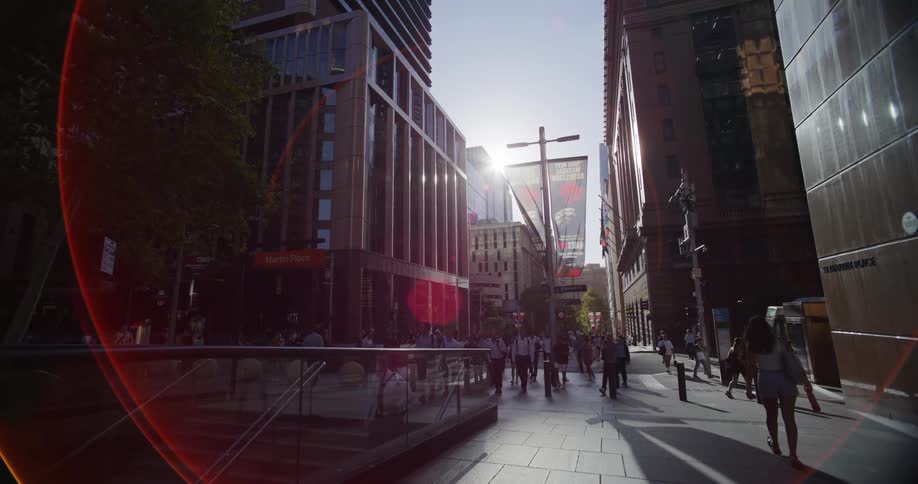 Pedestrians walking along an urban street in a metropolis during the day