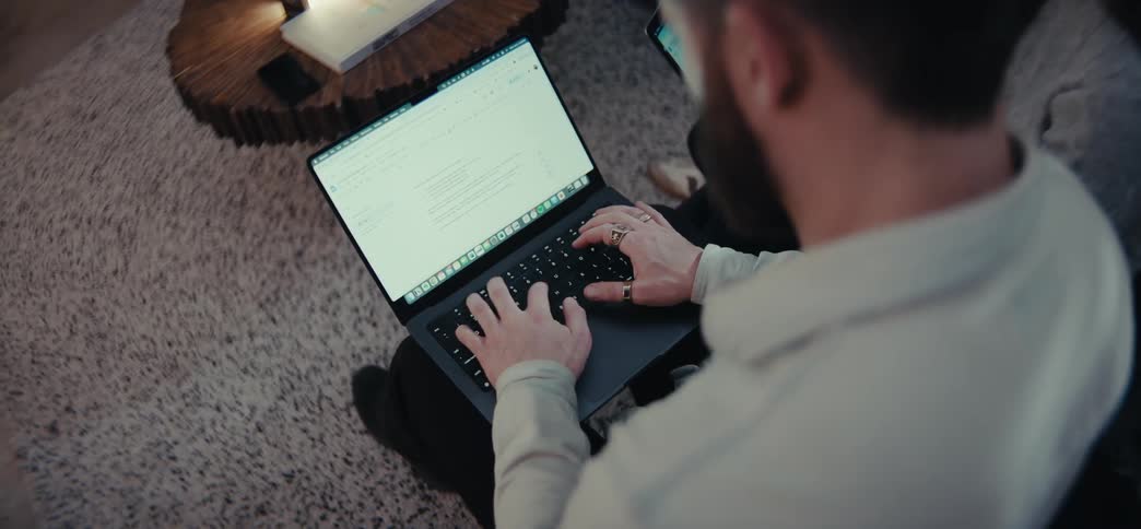 Man sitting typing on a laptop