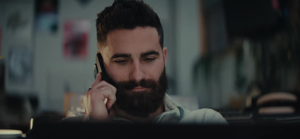Bearded man answering a phone call