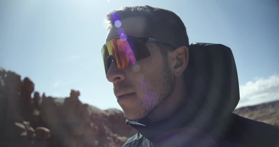 A man puts on a pair of sunglasses