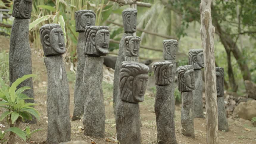 A row of wooden statues sit on this hill