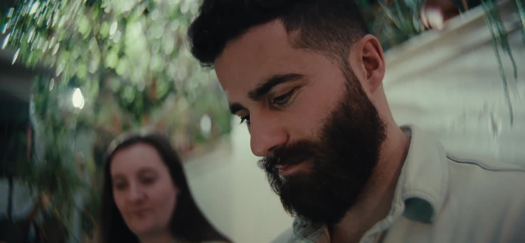 Portrait of a bearded man in a backyard next to a woman