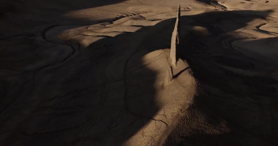 Aerial view of a desert valley with steep formations