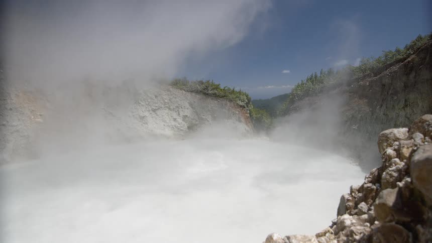 Steam rising up in a cove-like area on a clear day