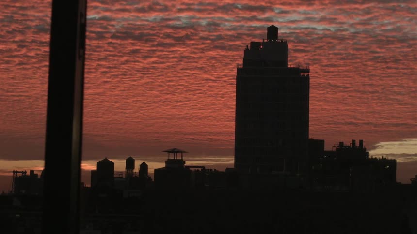 Red clouds above a city at dusk