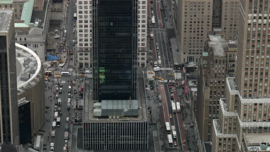 Traffic and pedestrians travel in a big city during the day