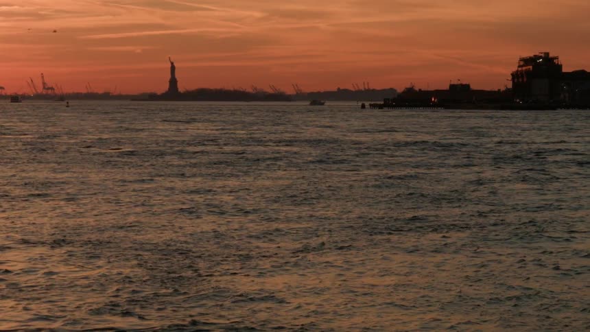 A body of water with a statue in the distance