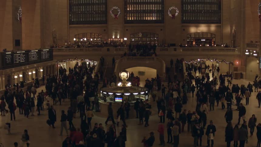 People buy tickets and walk through grand central station
