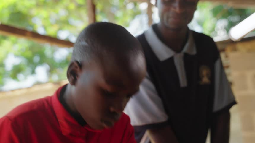 Portrait of a boy working with a saw next to an adult man