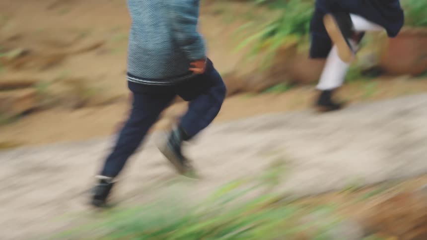 Children race towards the house