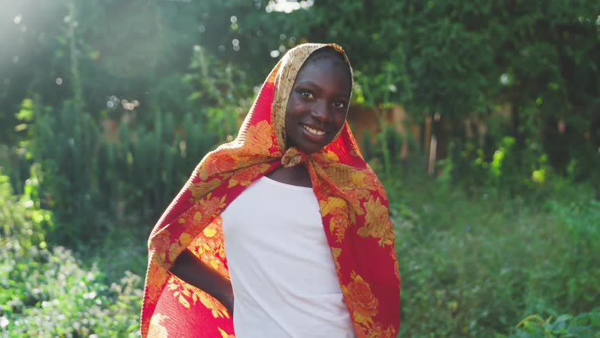 Woman in a field with a scarf on her head